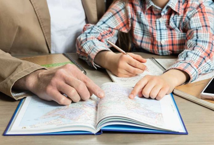1688065165 featured image Man and child studying map together at table