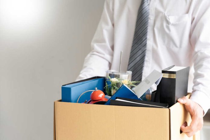 shutterstock_1487870660.jpg featured image Person holding a box of personal office items.