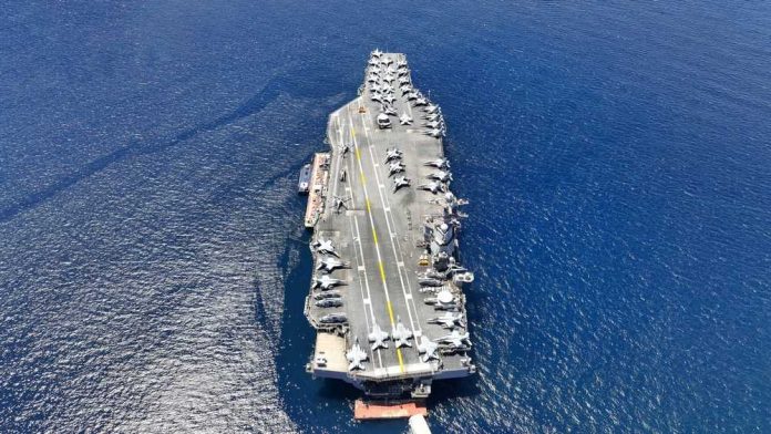 shutterstock_2354939185.jpg featured image Aircraft carrier on open sea with parked planes