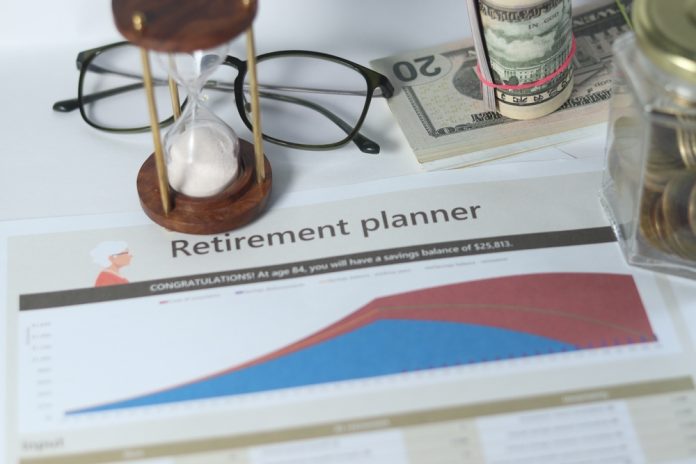 shutterstock_2485751417.jpg featured image Retirement planner graph with money glasses hourglass