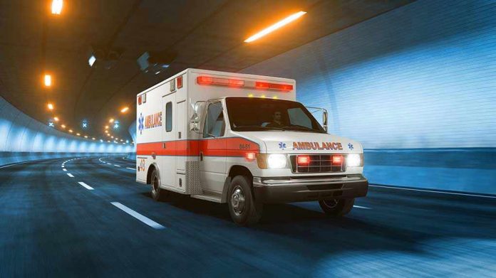 1159851319 Ambulance driving through a brightly lit tunnel