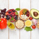 Assortment of healthy foods on wooden background