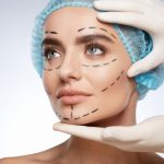 Woman with surgical markings on face wearing cap