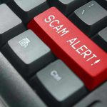 Close-up of keyboard with red SCAM ALERT key.