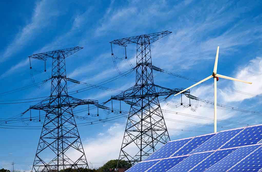138865700 Power lines, solar panels, and wind turbine against sky.