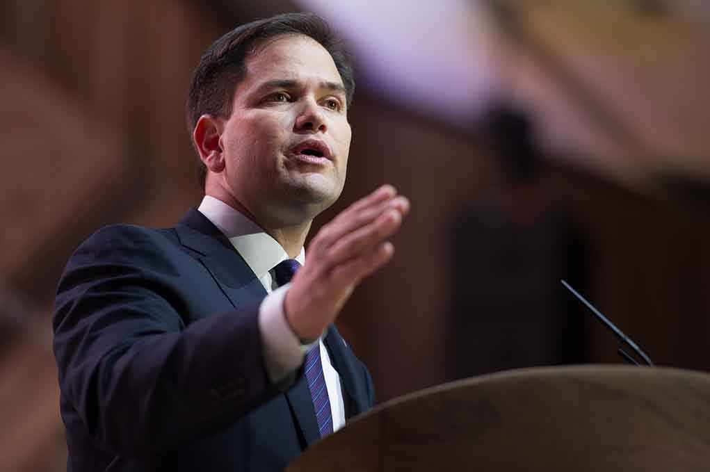 shutterstock_180970274.jpg A man in a suit delivering a speech at a podium