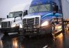 NEW Trucker Plan Sparks Nationwide Fury – STRICT Requirement! Two trucks driving on a wet road.