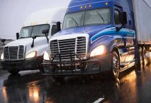 NEW Trucker Plan Sparks Nationwide Fury – STRICT Requirement! Two trucks driving on a wet road.