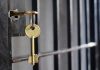 Imprisoned PM ATTACKED—Gang Threat Erupts! Key in lock of prison cell door.