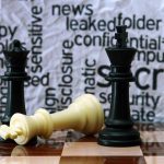 Chess pieces with secretive background text pattern