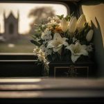 White flowers in a car with blurred background.