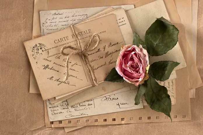 shutterstock_106626563.jpg A collection of vintage postcards and a dried rose arranged on a textured background
