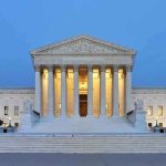 The U.S. Supreme Court building illuminated at night