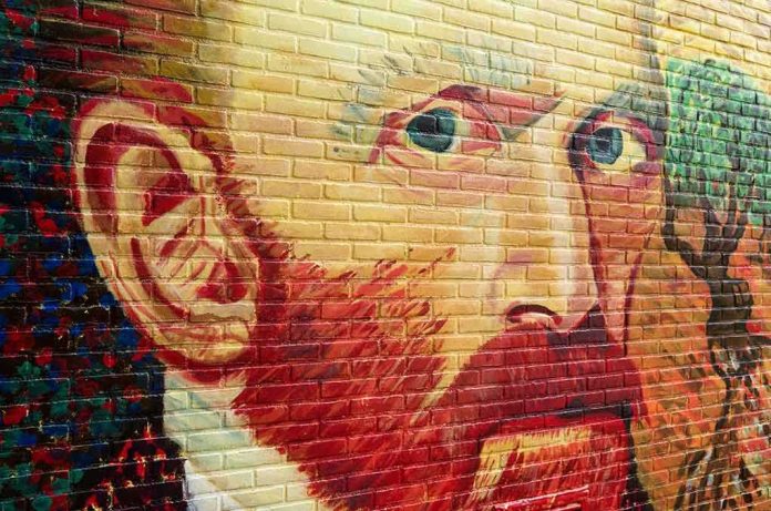 shutterstock_168108524 (1).jpg Colorful mural of a mans face on a brick wall