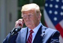 World Leader RIPS Trump – Tectonic Shift in Relations Man in a suit adjusting an earpiece.