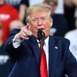 Trump UNLEASHES After GOP Tries Silencing Him Man in suit pointing, speaking at a rally.