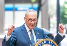 Schumer Meltdown—Dems Erupt, Chaos Unleashed Man in suit and glasses speaks passionately at podium.