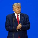 Letitia James Case EXPLODES – Trump DOJ Reverses Course Man in a suit with a blue background.