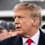 Trump Demands Arrests – Lawmakers Branded Traitors Man in suit and red tie speaking outside.