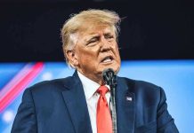 Autopen Presidency EXPOSED – Trump CANCELS ALL! Man in suit speaking at a microphone.