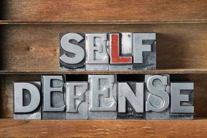 Metallic block letters spelling SELF DEFENSE on wooden shelves.
