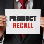 Government ANNOUNCES Recall – Customers Instructed to DESTROY Product Product Recall sign held by person in suit.