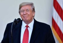 Trump DESTROYS Century-Old Court Protections Man in suit and tie speaking at podium.
