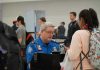 Real ID Takeover Triggers TSA Surveillance Nightmare TSA agent checks passengers documents at airport security.