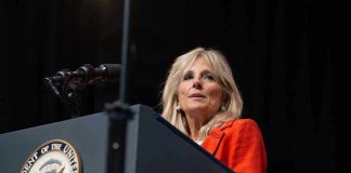 Person speaking at podium with Vice President seal.