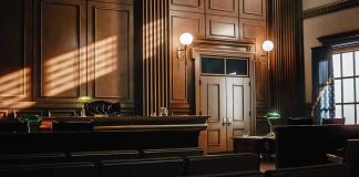Empty courtroom with judges bench and wooden decor.