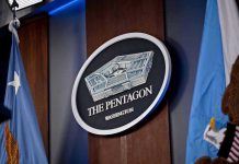 Navy Admiral DEFENDS Hegseth – Says He DIDN’T Do It The Pentagon emblem between two flags.
