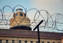 Guards Intercept BIZARRE Prison Smuggling Attempt – It’s Not What You Think Barbed wire in front of a prison tower.