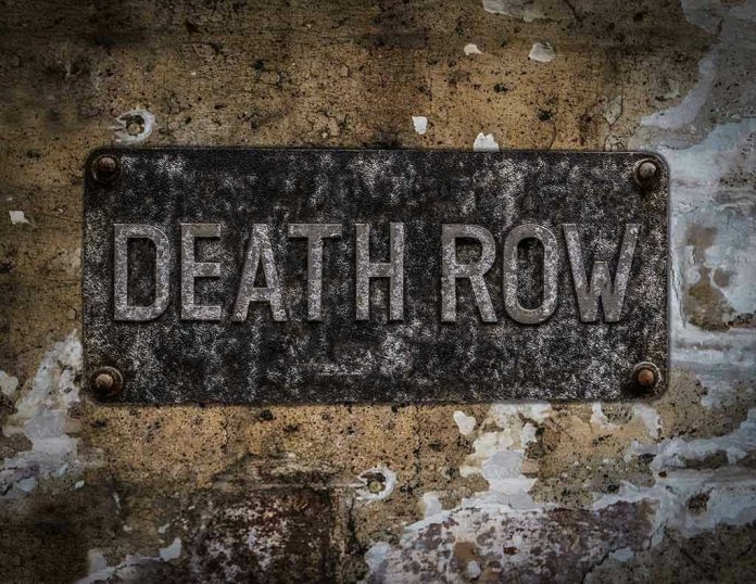 533872477 Weathered Death Row sign on aged concrete wall