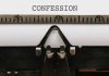 Typewriter typing the word confession on paper