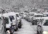 Dual Snow Storms COLLIDE – 45 Million Americans Impacted Traffic jam with cars covered in heavy snow during a snowstorm