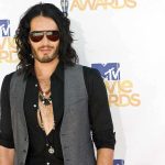 A man with long hair and sunglasses posing at the MTV Movie Awards
