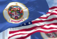 Trump DELIVERS a SCATHING Message to Minneapolis Leadership Minnesota state flag with American flag in background.