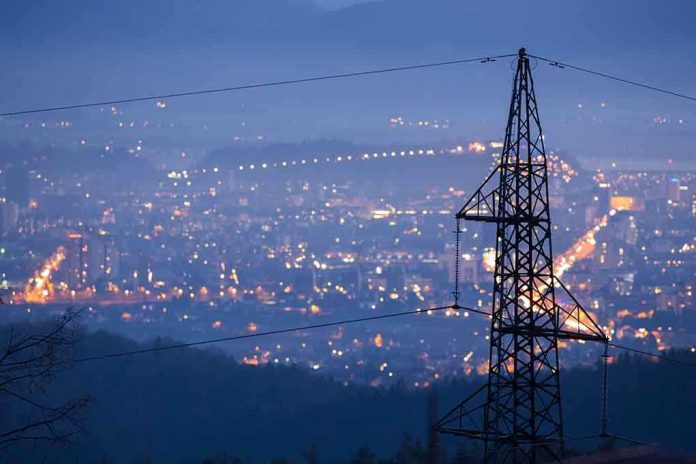 shutterstock_239384182.jpg Night view of a city skyline with power lines in the foreground