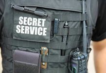 Secret Service Agent SHOOTS Himself On Duty Secret Service vest with various tactical gear attached.