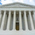 SCOTUS Hands GOP Redistricting Win Building with columns under a cloudy sky.