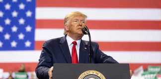 Trump Comforts Two Grieving Moms After THIS Happened Man speaks at podium with U.S. flag background.