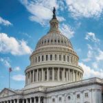 Congressman Threatens Reporter – Shoves Gun In The Face! U.S. Capitol building dome under clear blue sky.