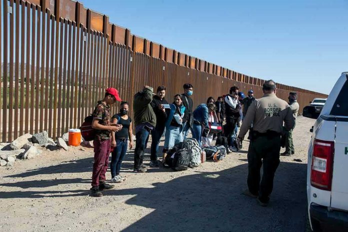 1973414822-1 Border patrol agents interact with a group of people.