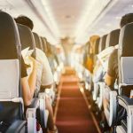 Airline Passenger Horror: Toenails Everywhere! Passengers seated inside an airplane cabin.