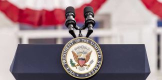 Vice Presidential podium with microphones and emblem.
