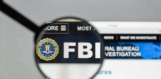 FBI CAPTURES MOST Wanted – He Was Hiding Where! FBI website shown through magnifying glass.