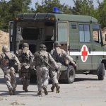 Trump Deploys Navy After Killer Quake Strikes! Soldiers running towards a medical vehicle during a military operation