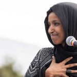 Ilhan Omar BROKE – Millionaire Mirage Vanishes! Ilhan Omar speaking at a microphone during an event