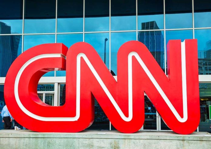 shutterstock_159663854 Large red CNN logo in front of a glass building