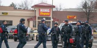 Police officers gathered outside King Soopers grocery store.